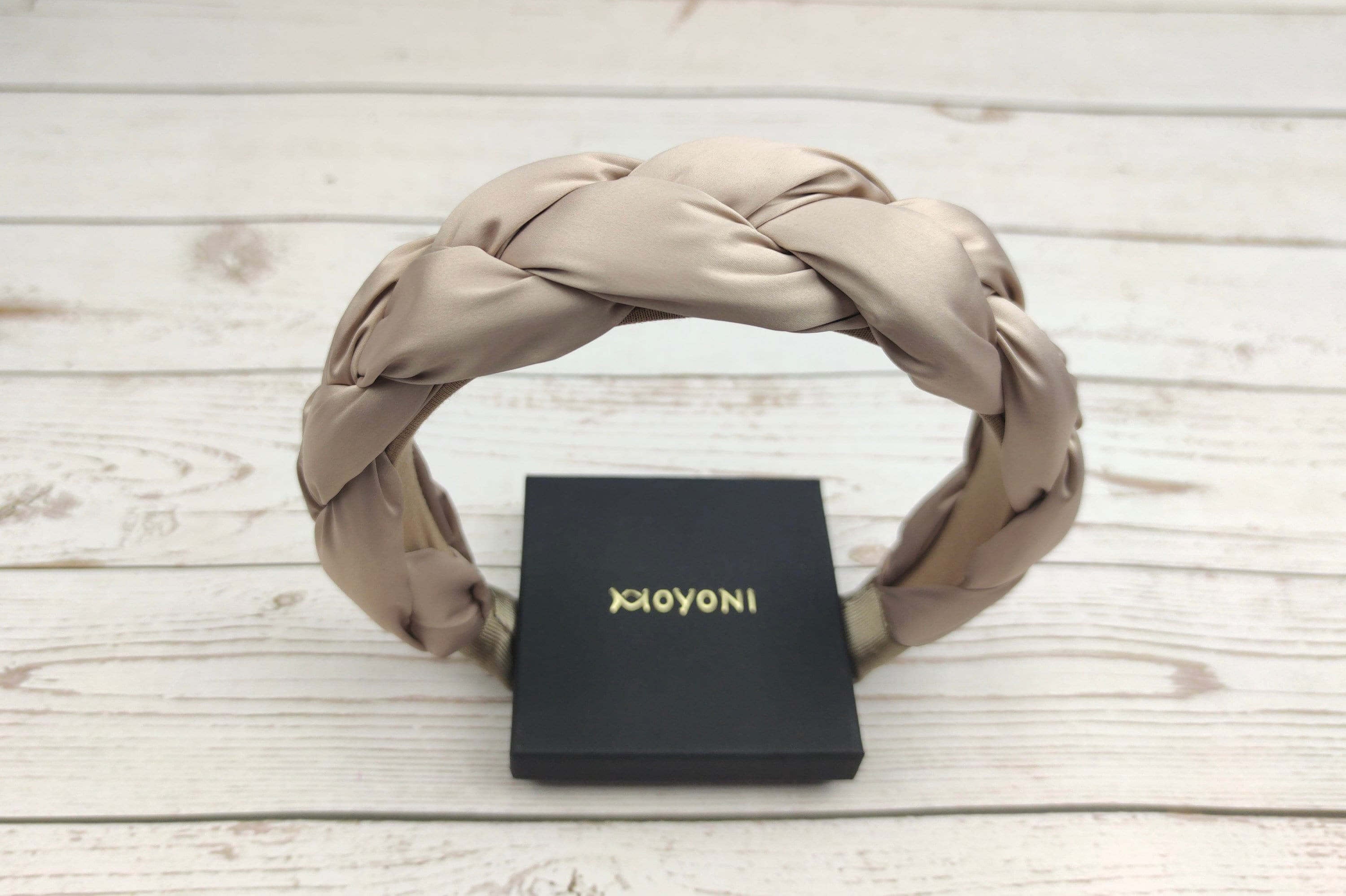 Spoil her with this luxurious beige satin headband, featuring a comfortable padded design.