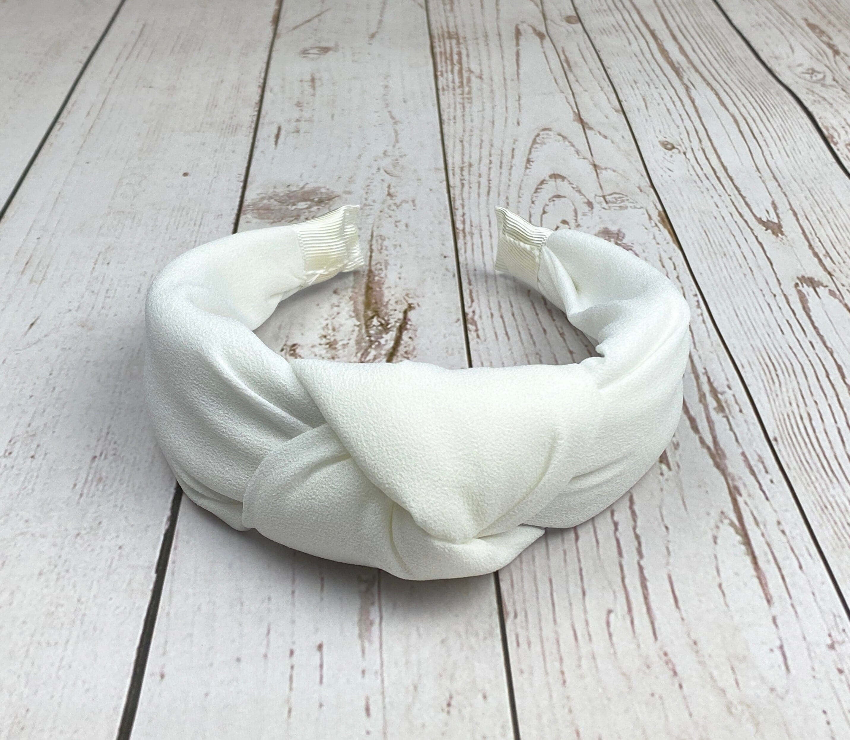 Add a touch of sophistication to your look with this snow-white padded headband.