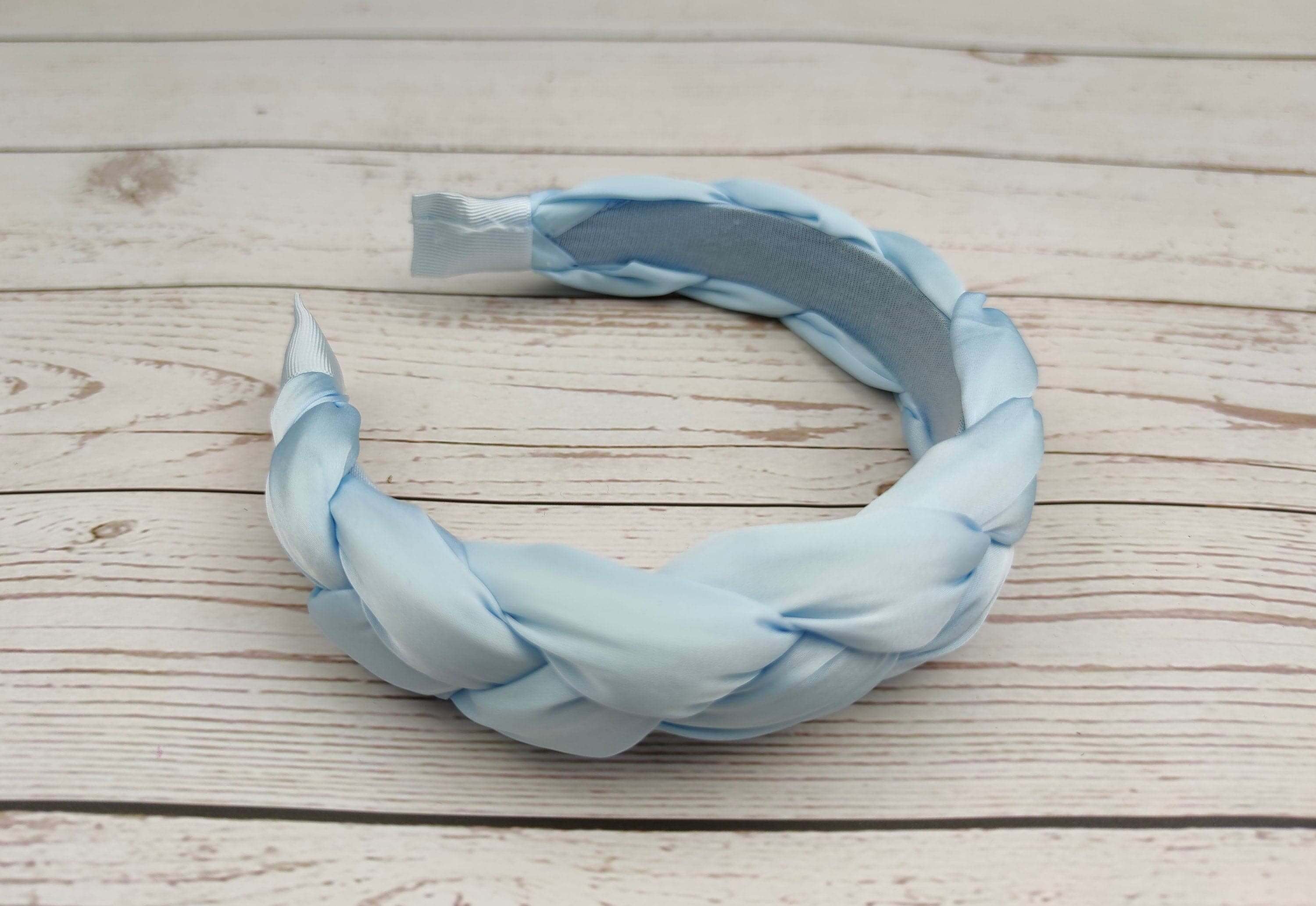 Elevate your hairstyle with this fashionable baby blue hairband.