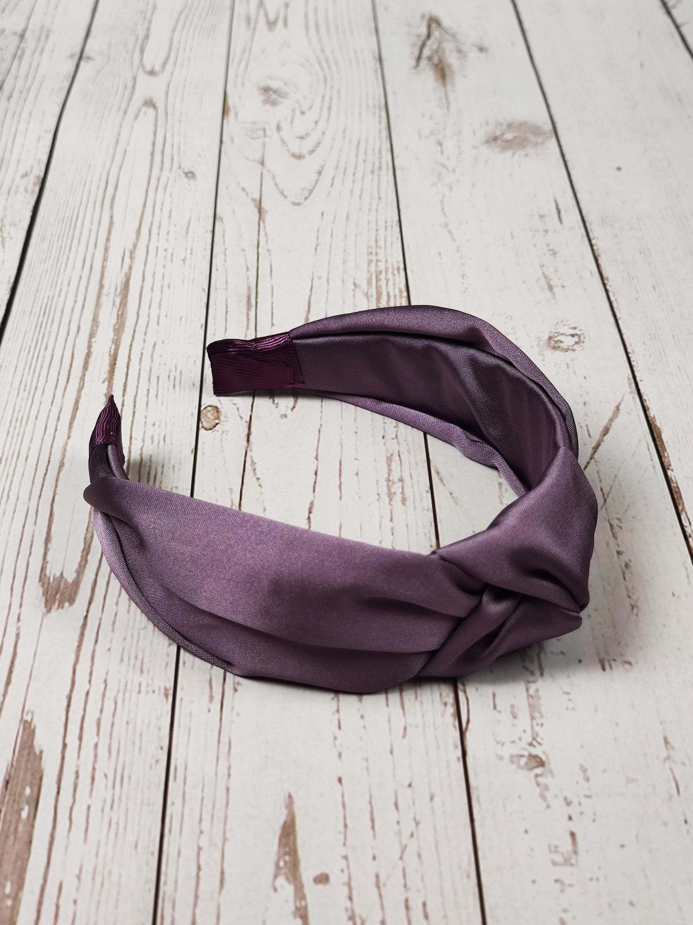 Bring the sunshine into your life with this pretty lilac satin headband. It will brighten up any day and add some much-needed color to your look.