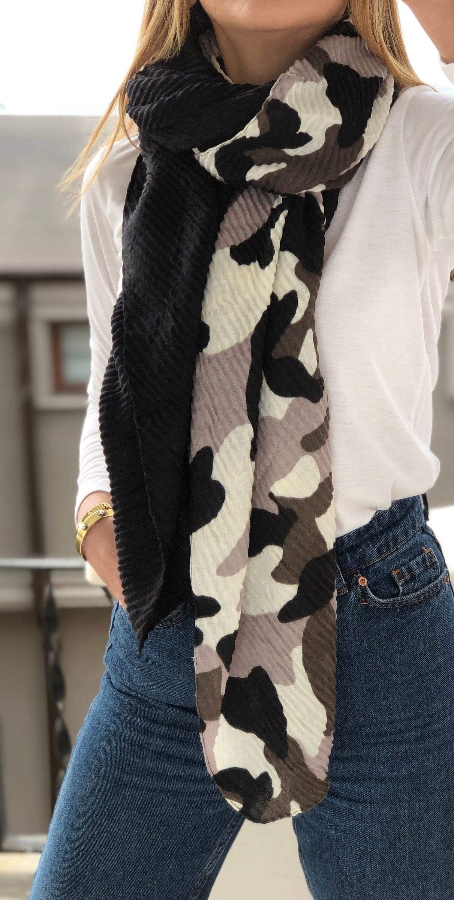 Stay warm in style with this grey, black and white camouflage patterned scarf for women.