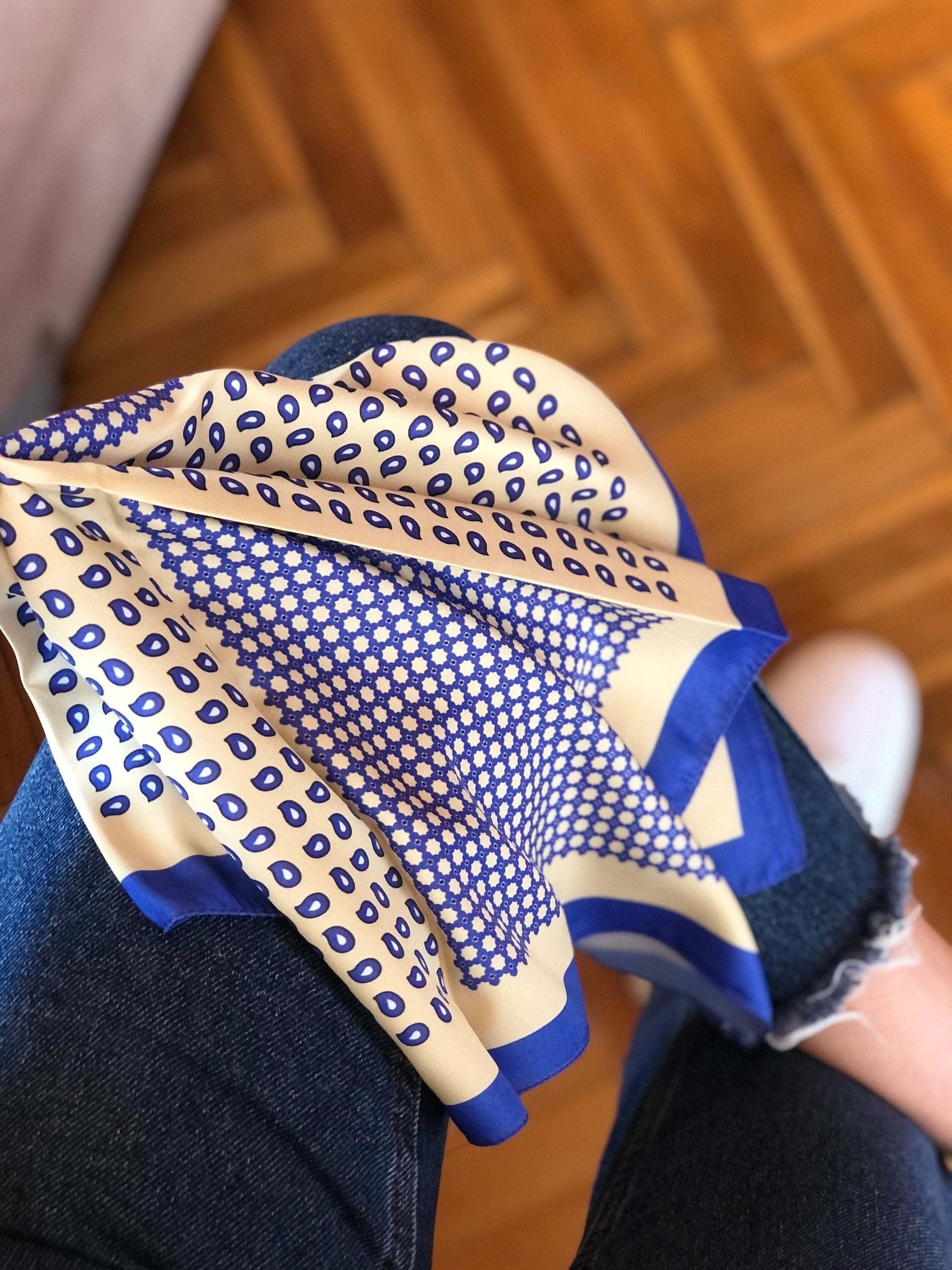Add a pop of color to your everyday look with this navy blue and yellow satin scarf. The versatile design can be worn as a head scarf or neck scarf, making it the perfect accessory for any occasion.