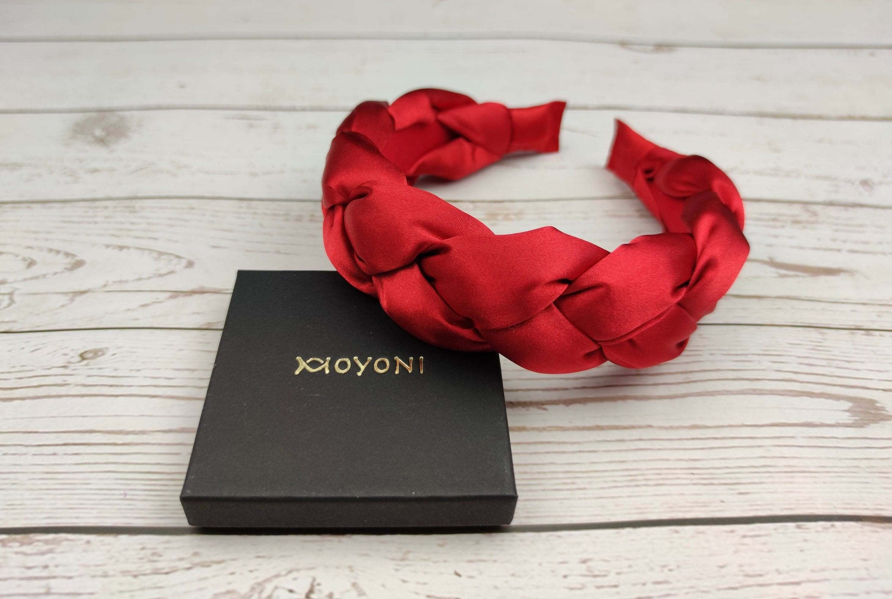 Make a statement with this elegant red satin headband, perfect for adding a touch of sophistication to your hairstyle.