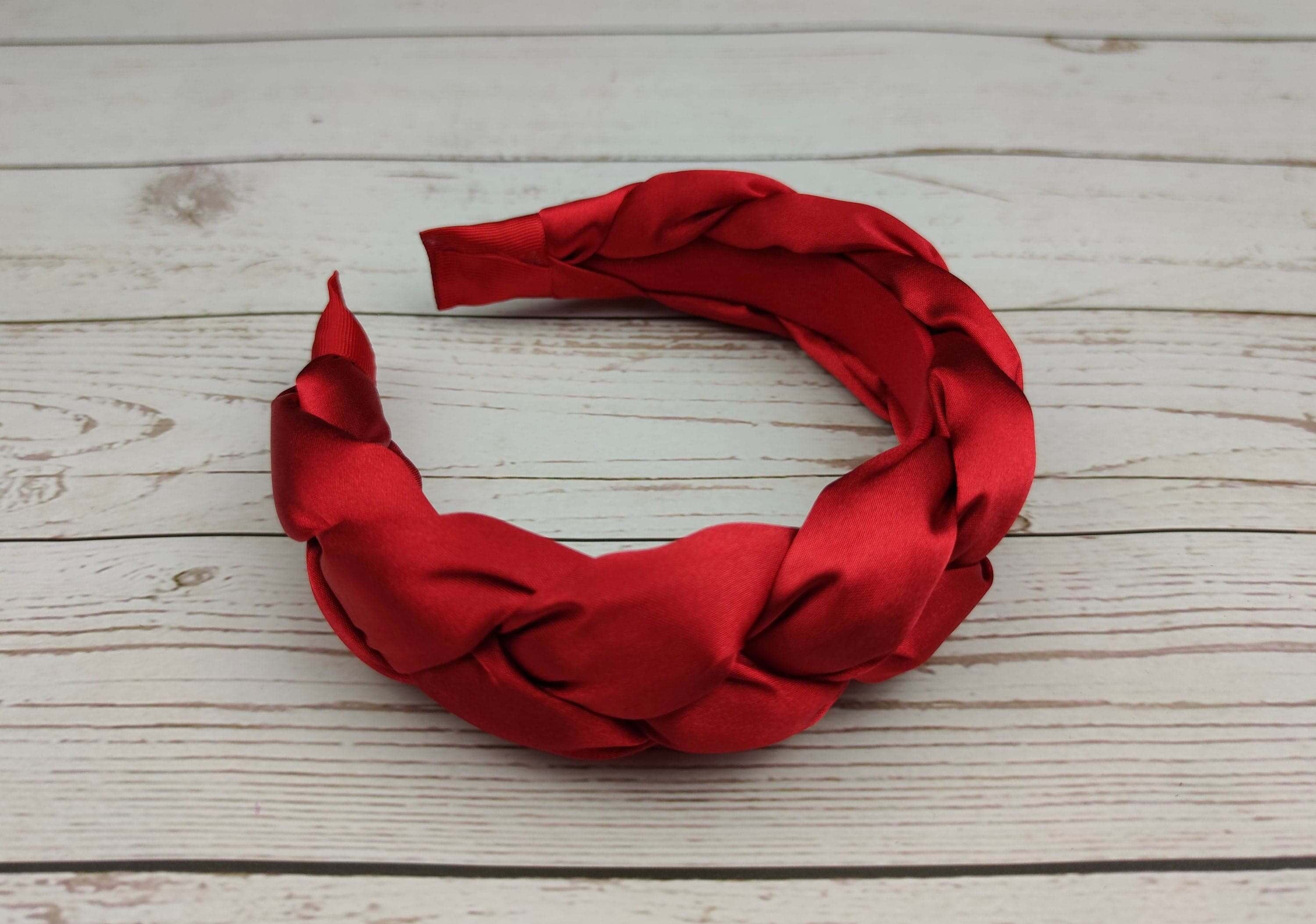 Elevate your accessory game with this beautiful and sophisticated red satin braided headband for women.