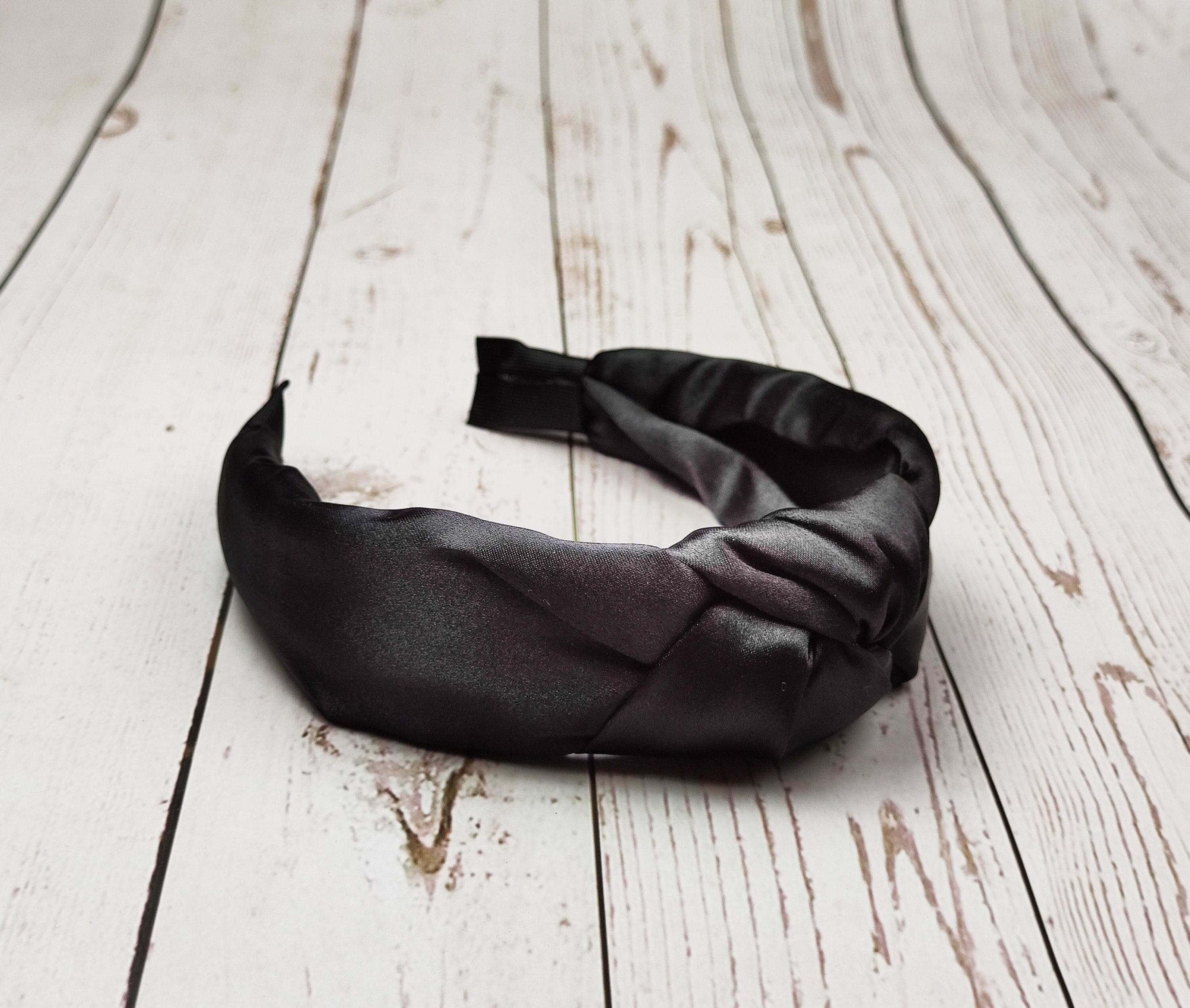 Elevate your accessory game with this chic and versatile black padded satin headband.