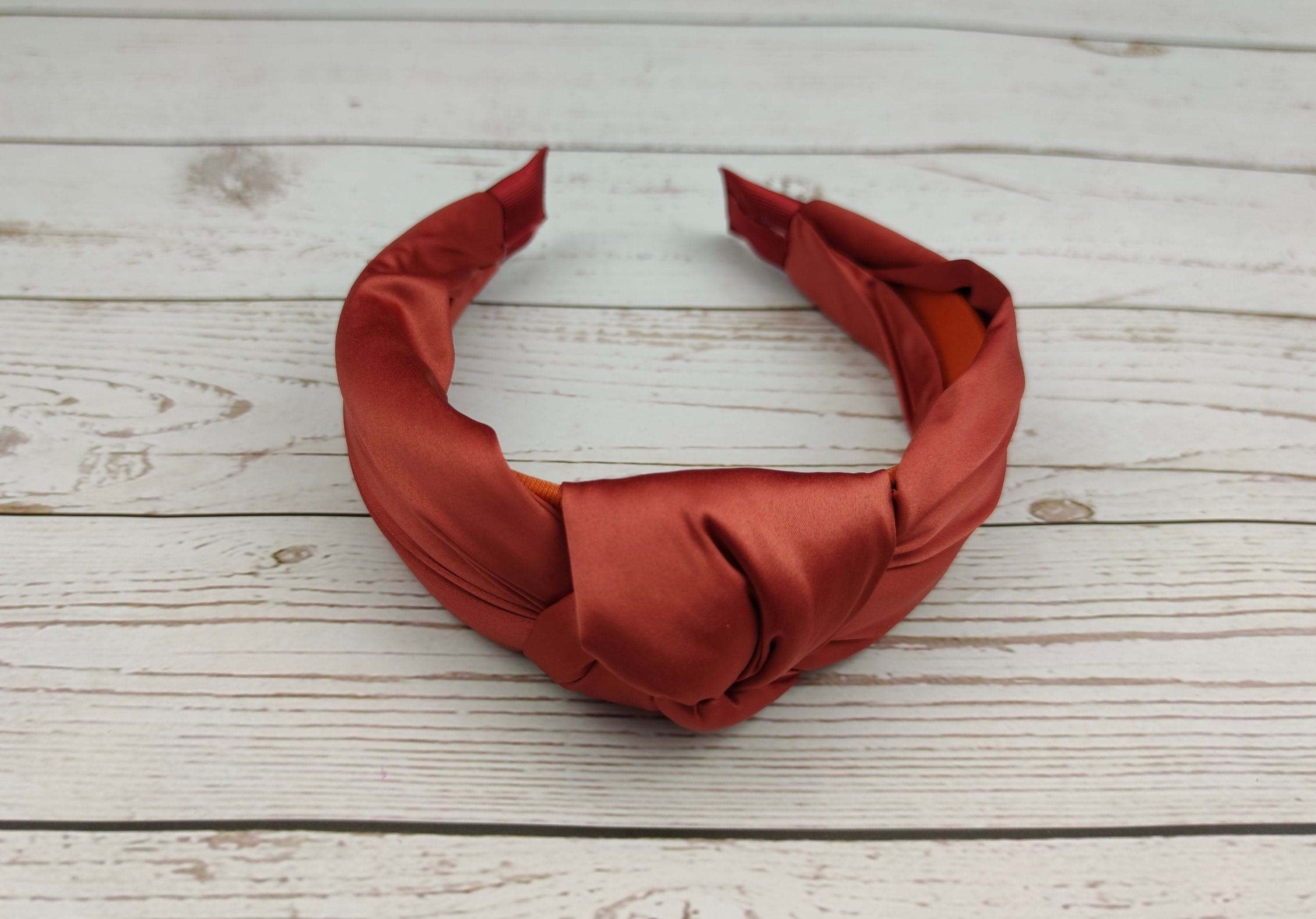 This twist headband is perfect for adding a touch of drama to your look. It is made from soft satin fabric and is easy to put on and take off.