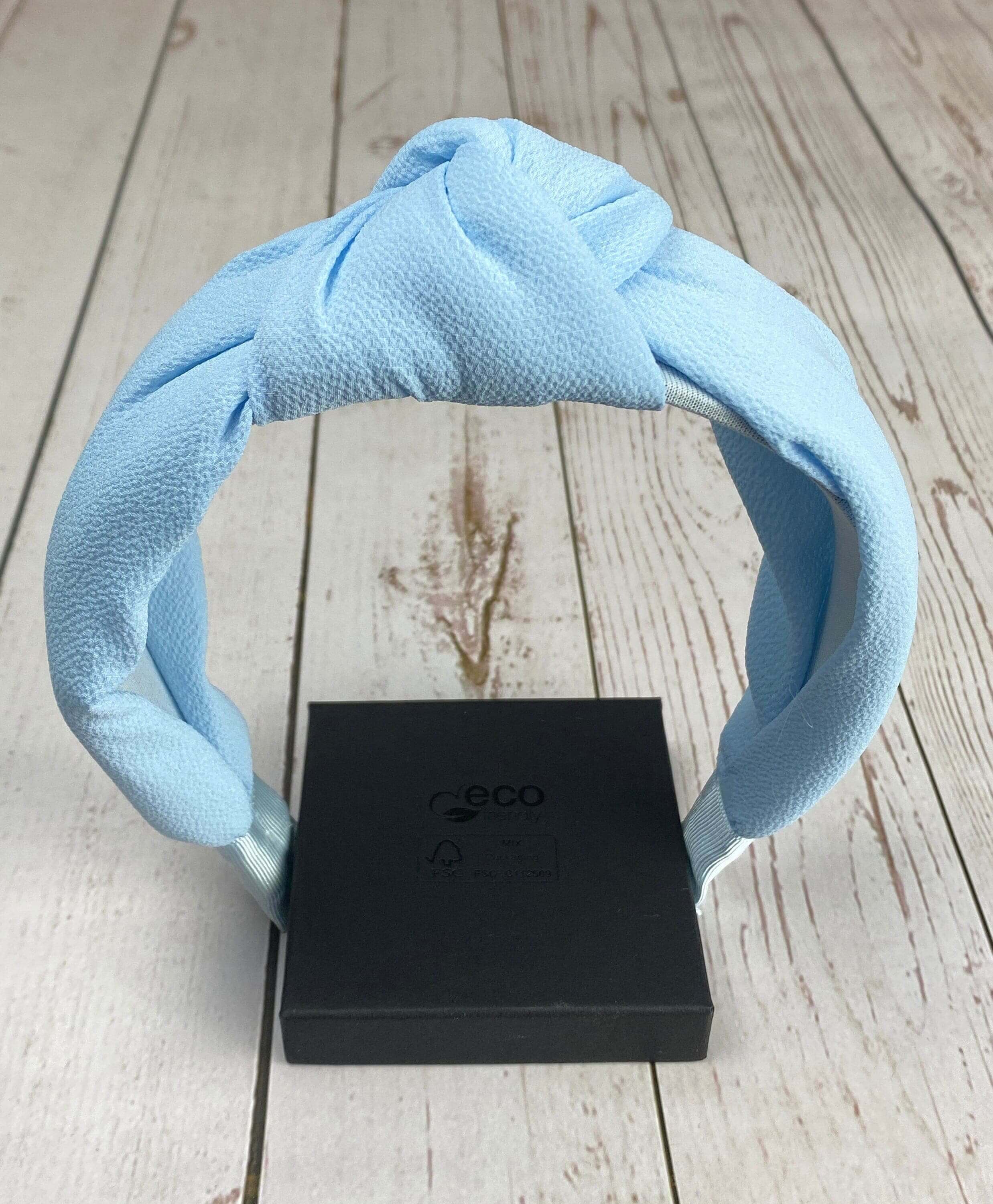 Elevate your hairstyle with this fashionable light blue headband, designed with a twist knot and padded for ultimate comfort.