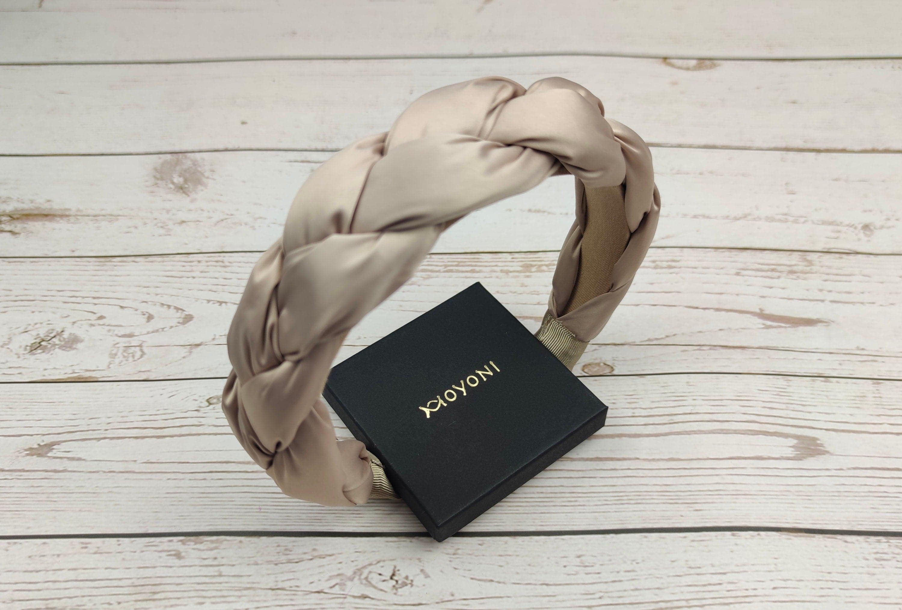 The perfect accessory for any summer outfit - a stylish beige satin headband for women.