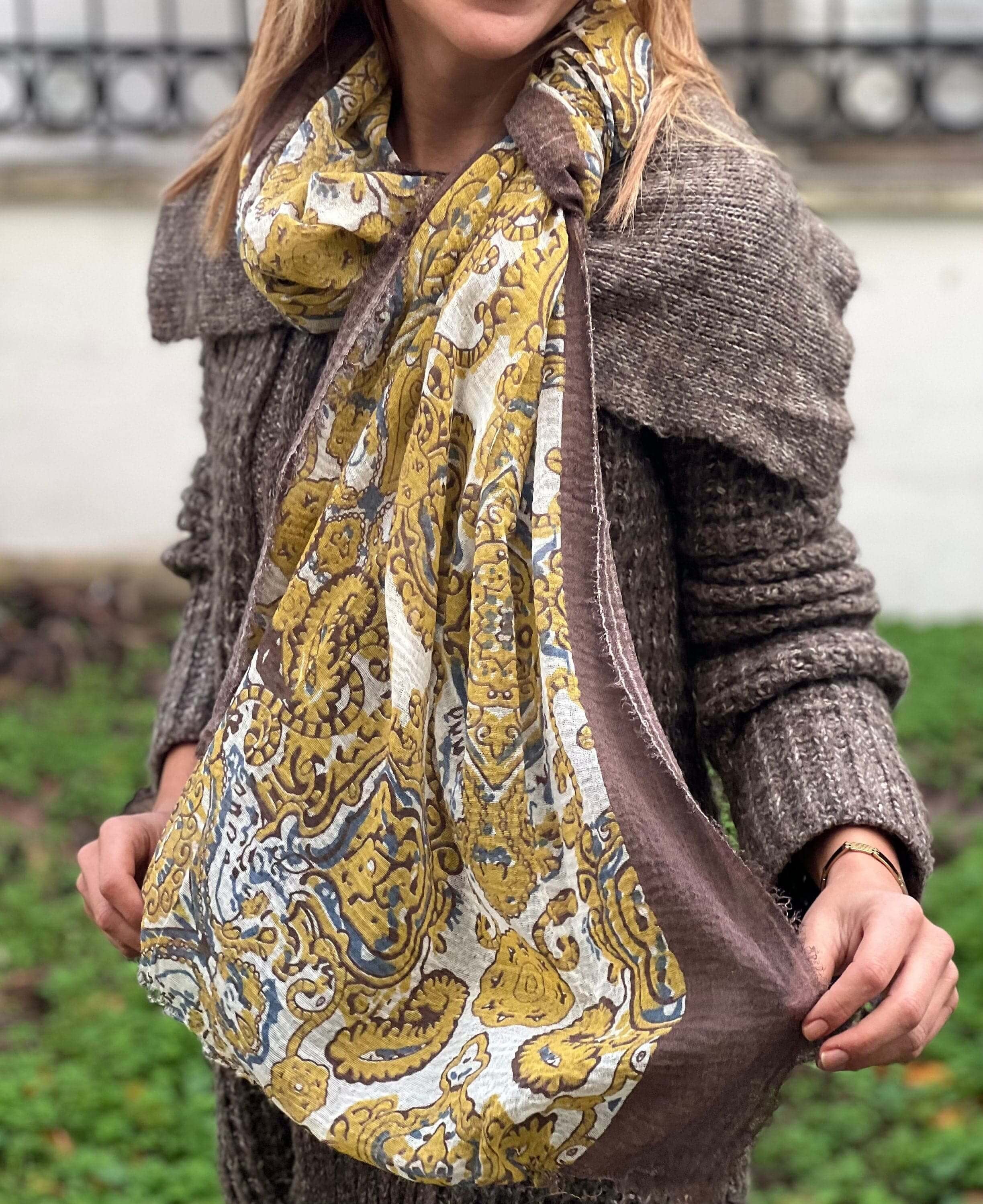 Stay warm and on-trend with this soft and cozy yellow and white ethnic pattern cotton scarf, perfect for any season.