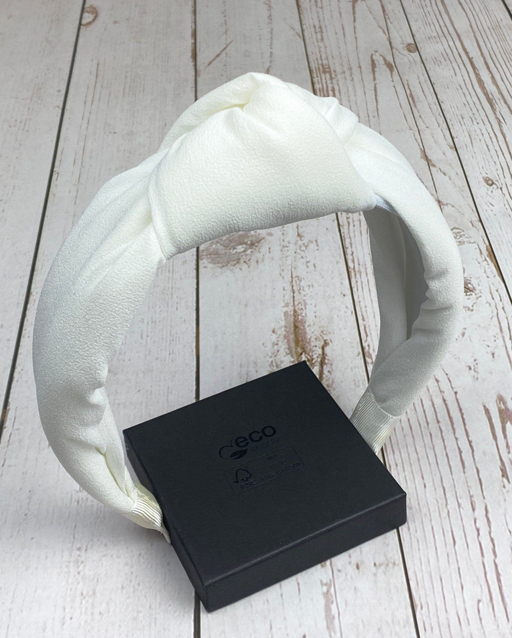 Perfect for brides, this white padded headband adds a touch of glamour to any outfit.