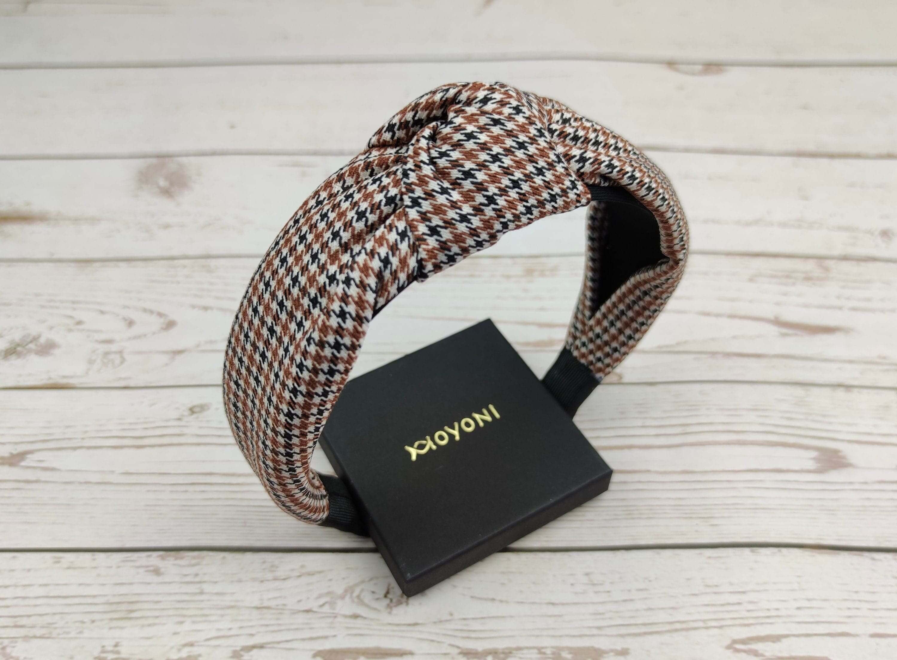 Add some sophistication to your everyday look with this versatile crepe white, black, and brown knotted headband. Perfect for college and any occasion, it is a must-have accessory for stylish women.