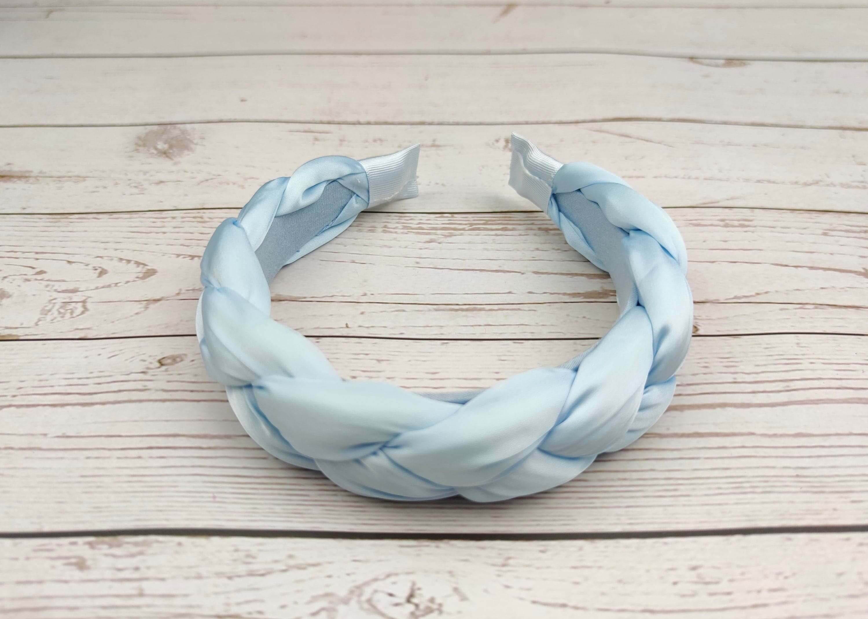 Transform your look with a knotted headband in soft satin fabric.