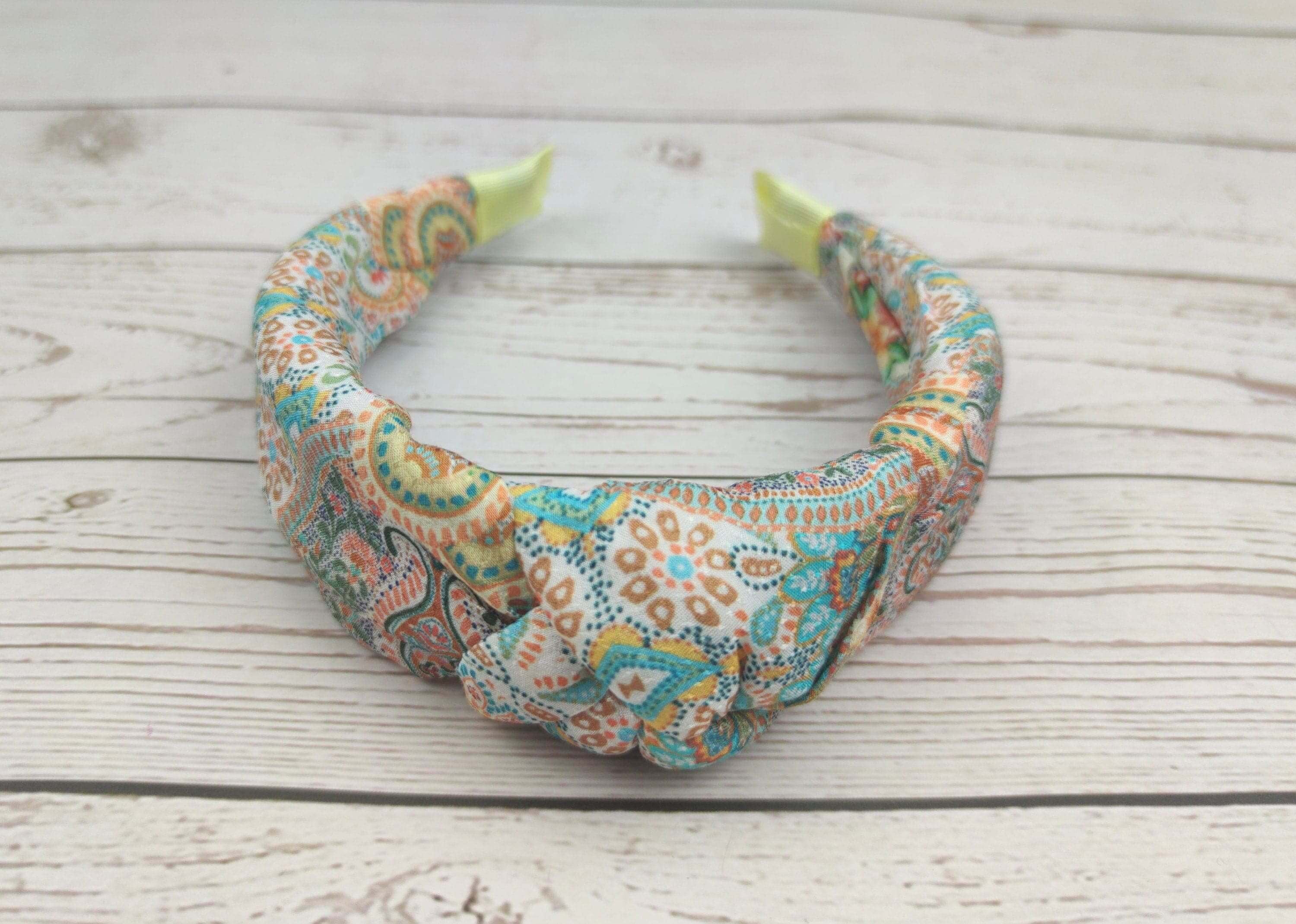 A fashionable headband with a knotted design that adds a pop of color to any outfit.
