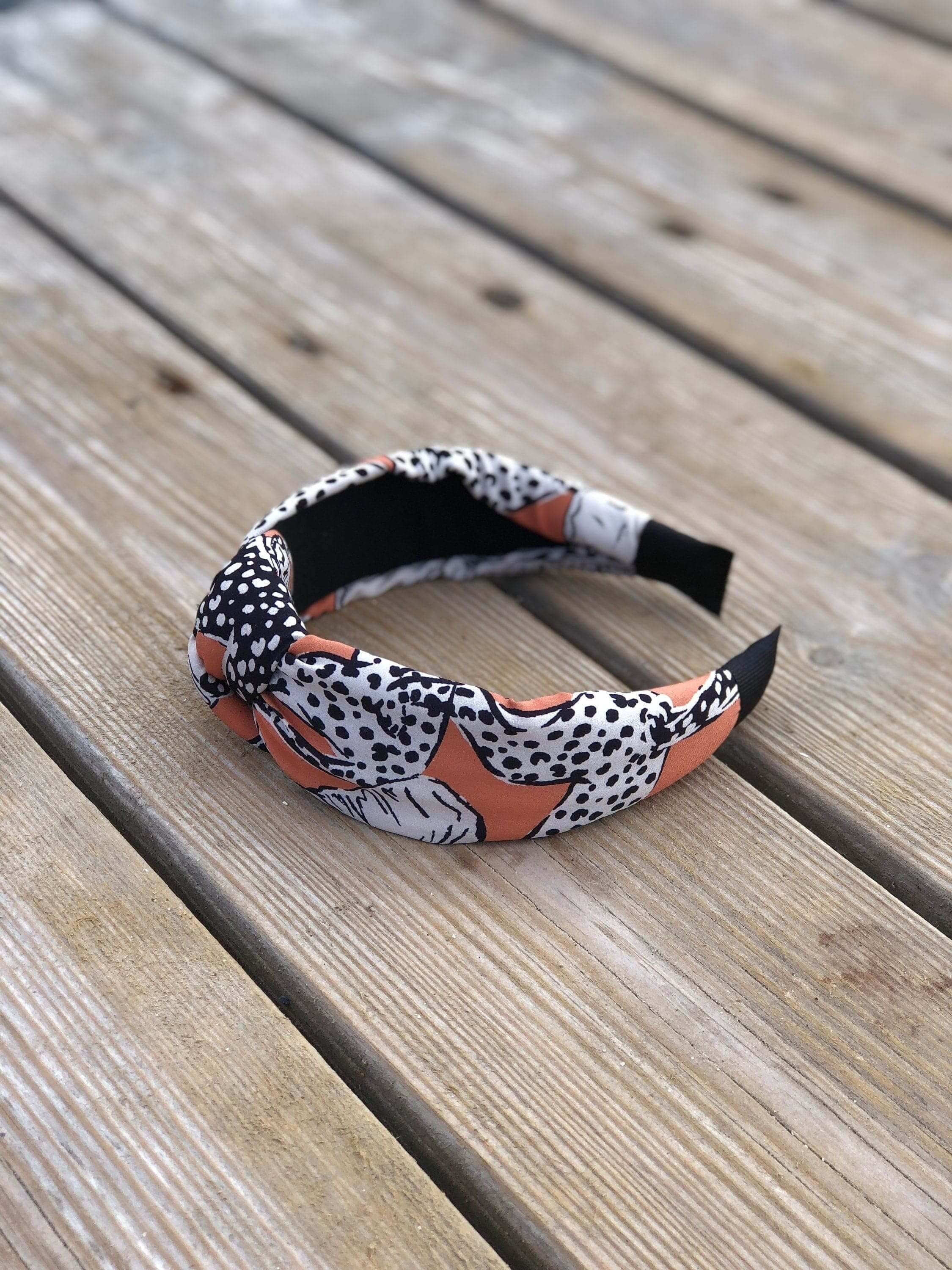 Add a touch of playfulness to your look with this Pinkish Orange Headband