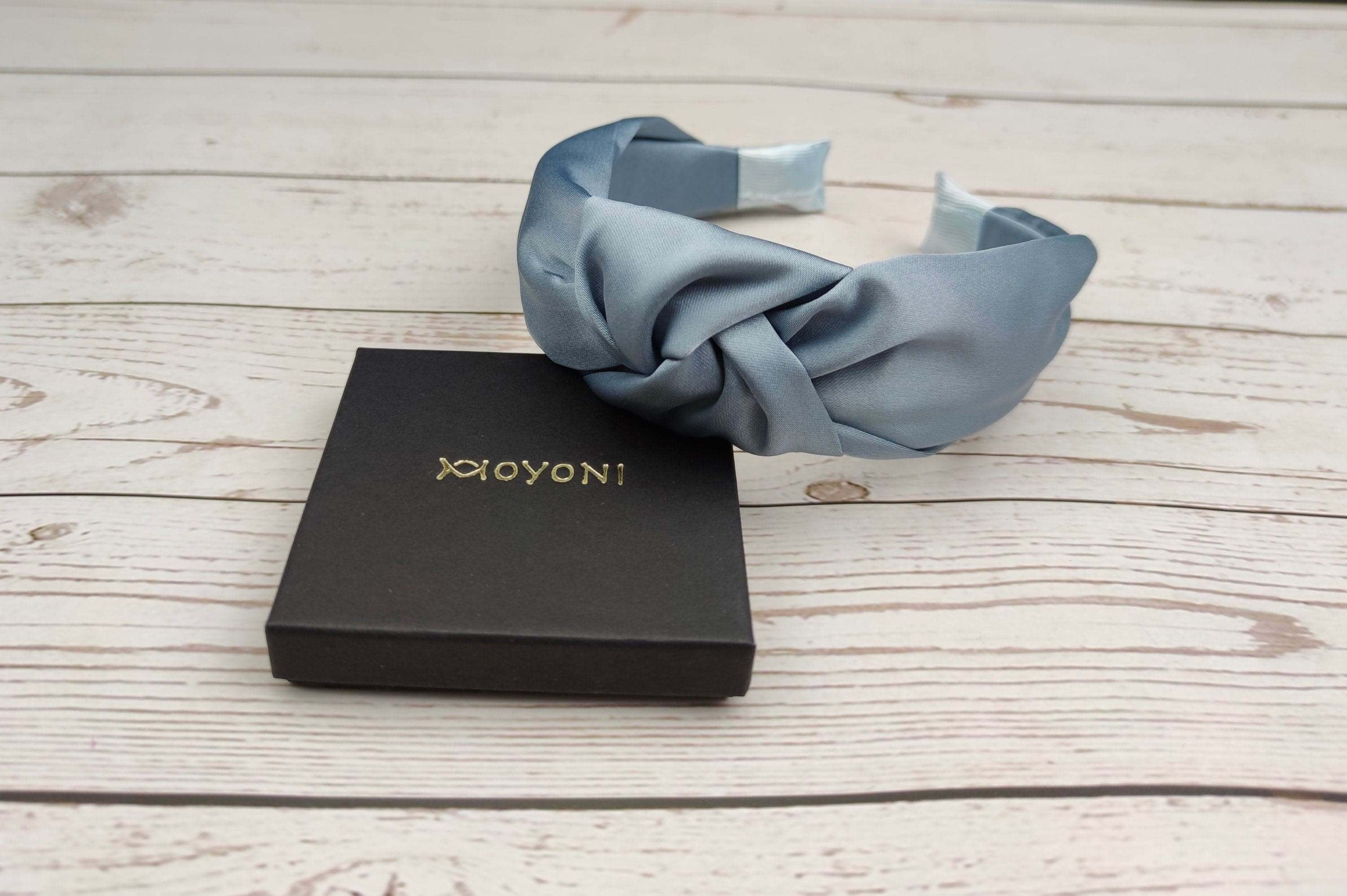 Add a pop of color to your hairstyle with this baby blue twist knot headband - a fashionable accessory for women.
