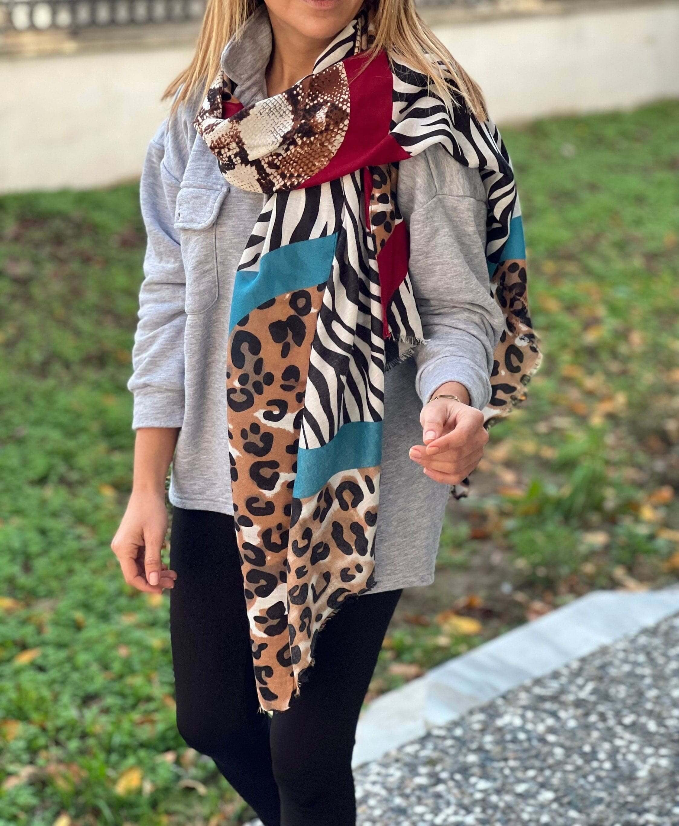 Add some wild style to your wardrobe with this stunning animal print scarf! Featuring a mix of leopard, zebra, and snake patterns, this scarf is the perfect accessory for any fashionista.