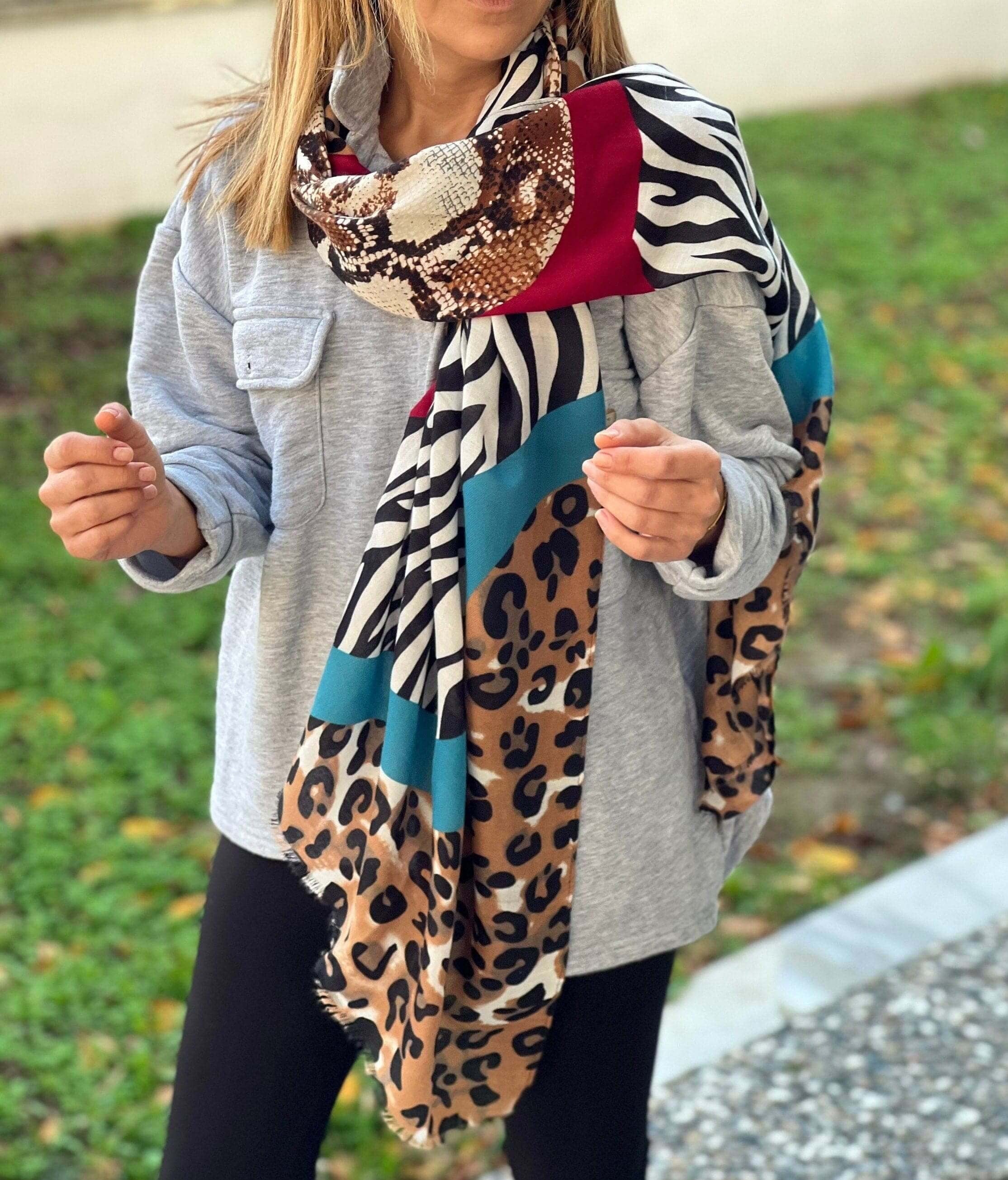 With its classic rectangular shape and bold animal print pattern, this scarf is sure to become a staple in your wardrobe. Pair it with jeans and a t-shirt for a casual look, or dress it up with a little black dress.