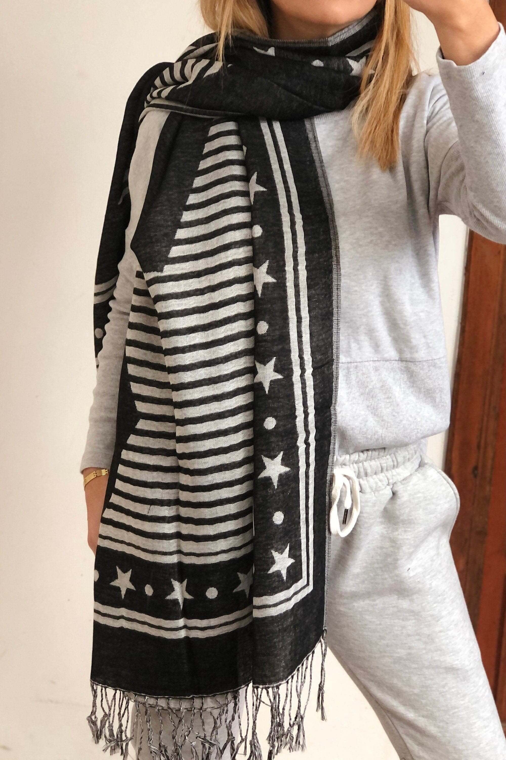 Star Pattern Cotton Scarf: A stylish cotton scarf featuring a fun star pattern in shades of black and white. Perfect for adding a touch of whimsy to any outfit.