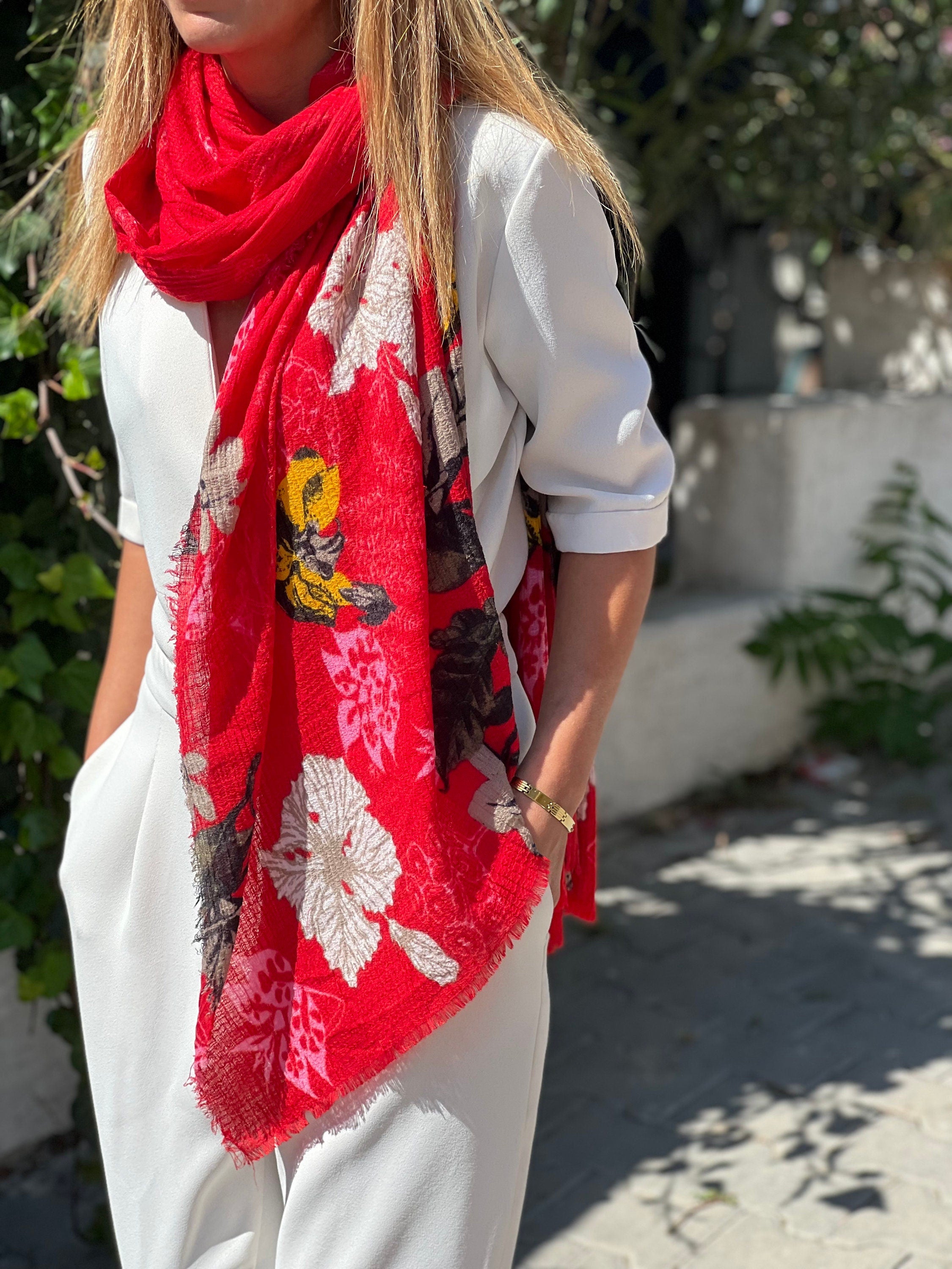 The bright red color of this scarf is sure to turn heads and make a statement.