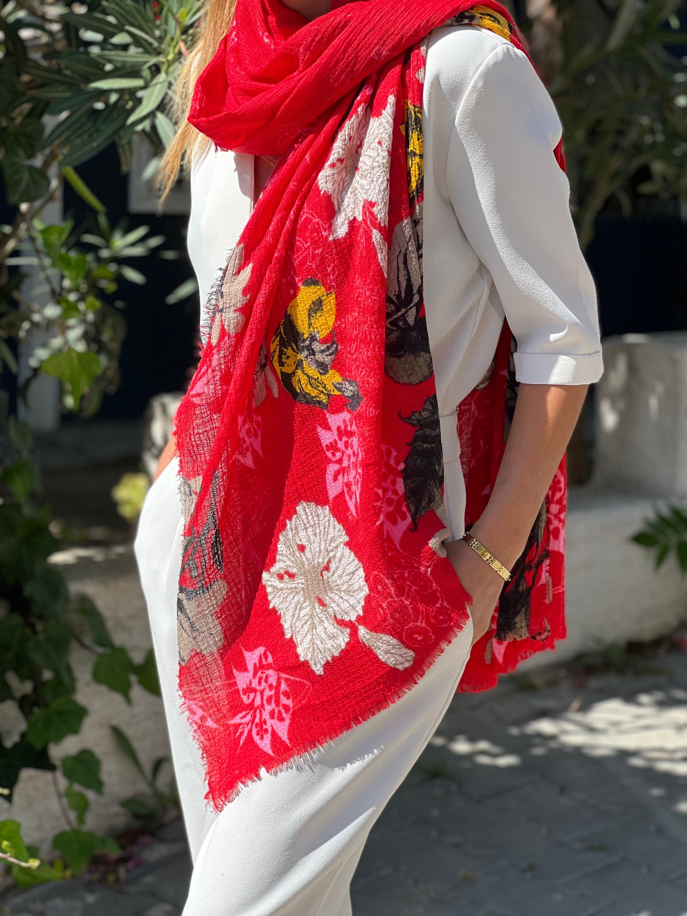 The floral design on this scarf is both classic and trendy, making it a versatile accessory for any wardrobe.