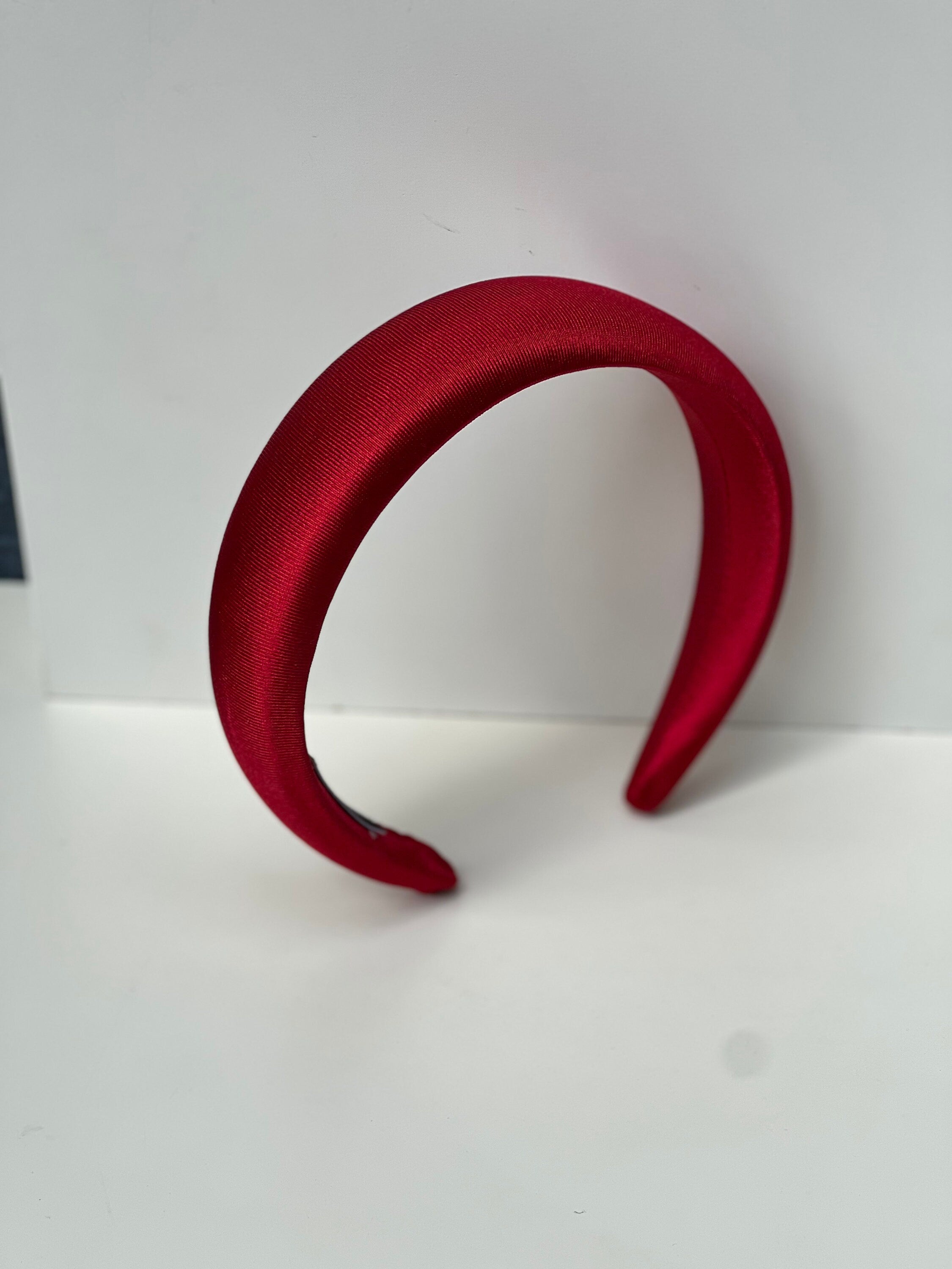 Stay comfortable and fashionable with this red padded headband, perfect for any outfit.