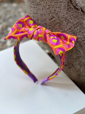 Make a statement with this vibrant multicolor silk bow headband