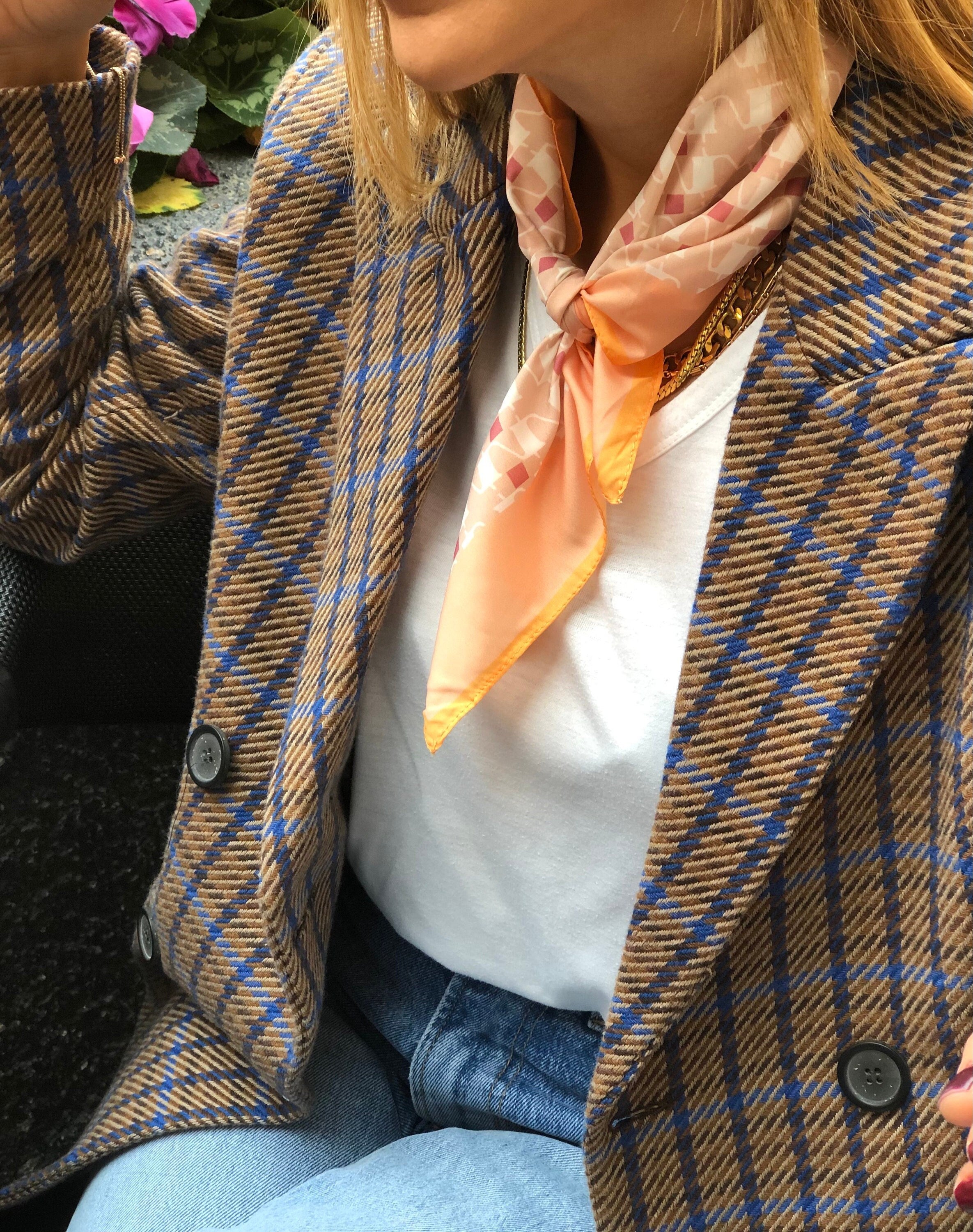 Elegant pinkish-orange geometric pattern silk blend scarf, perfect for spring.