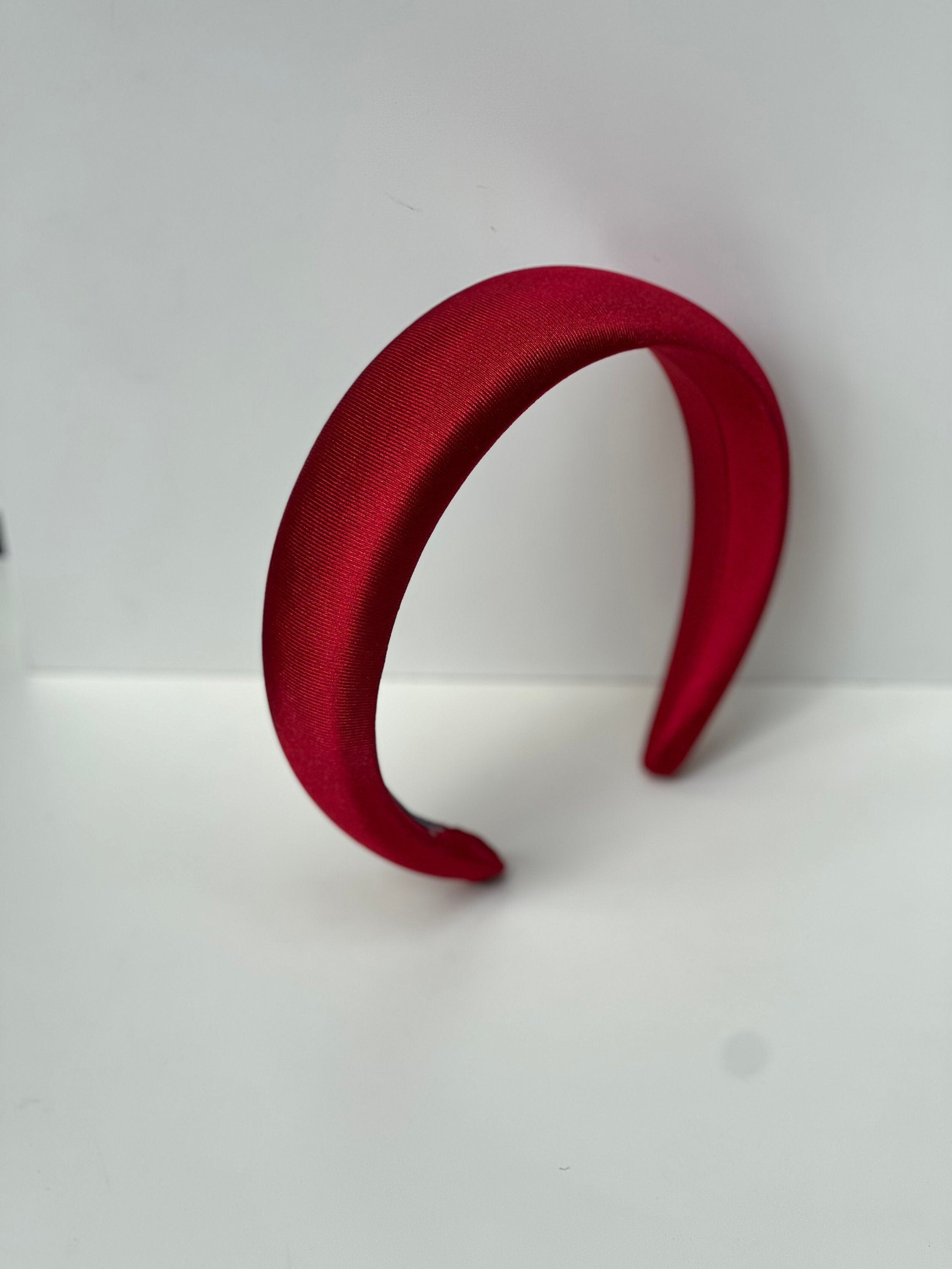 Make a bold statement with this bright red satin headband, a chic accessory for women.
