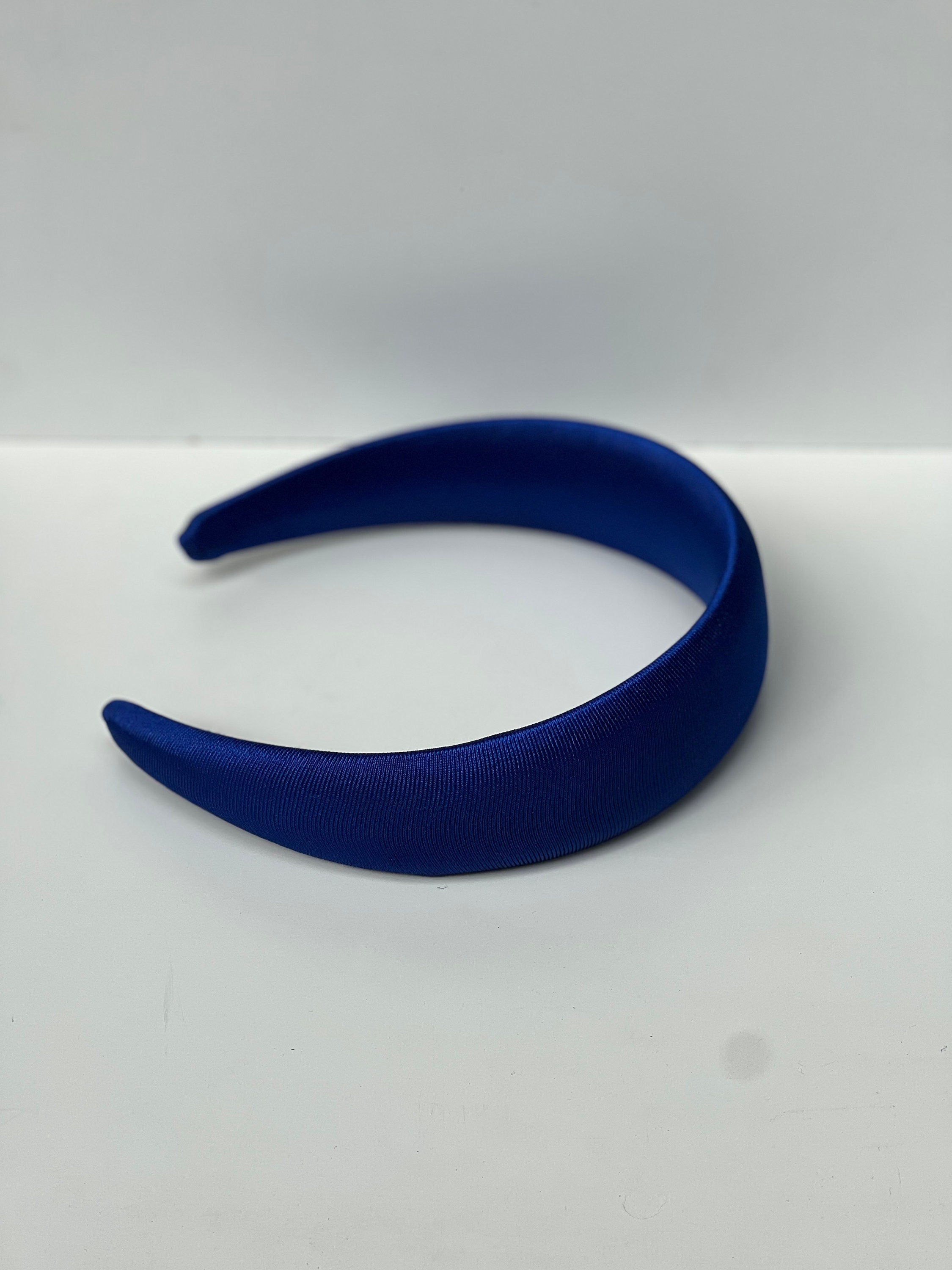 Elevate your accessory game with this fashionable and padded bright blue satin hairband, perfect for special days or everyday wear.