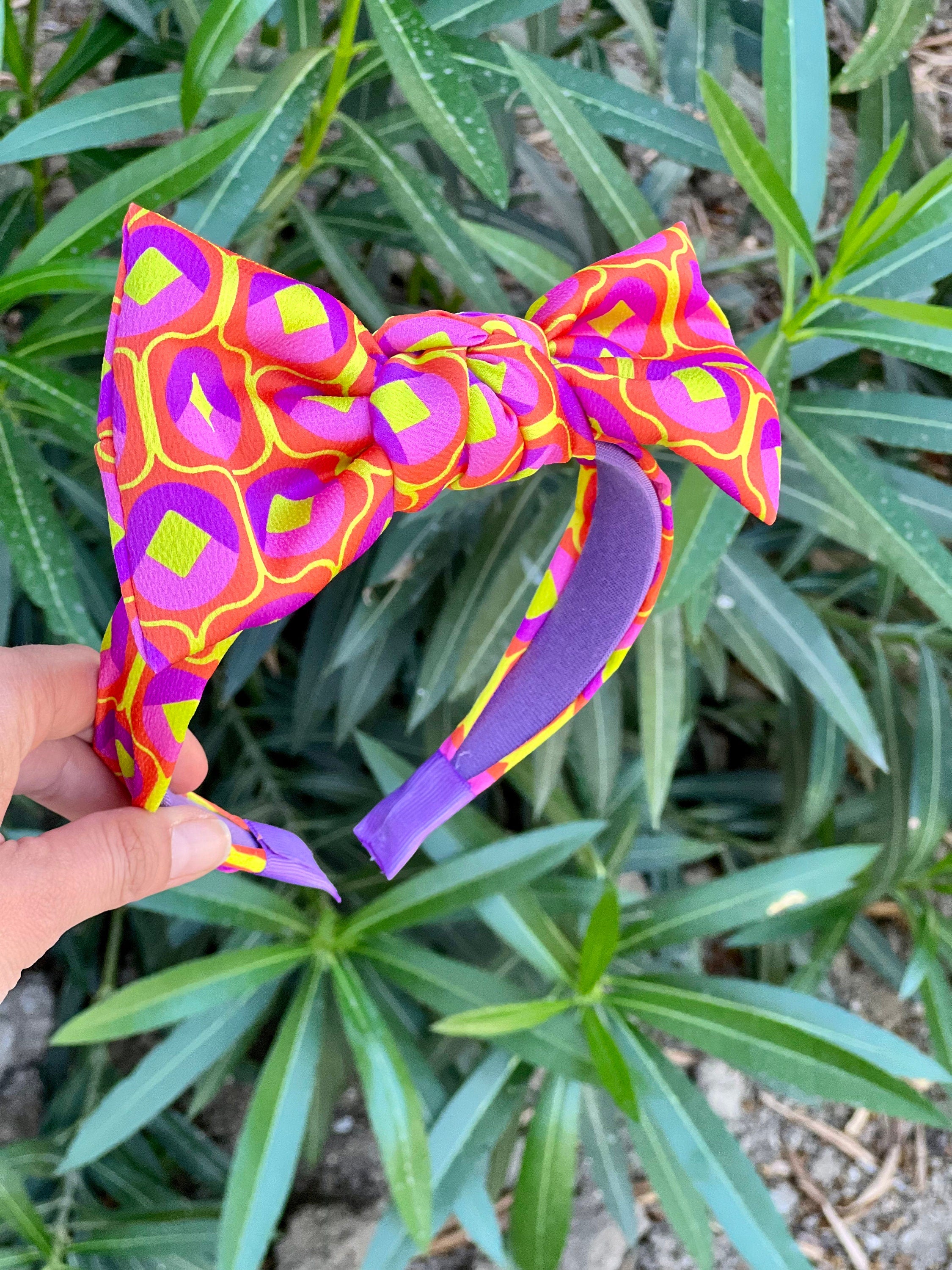 Stay stylish and comfortable with this purple orange yellow patterned hair tie headband.
