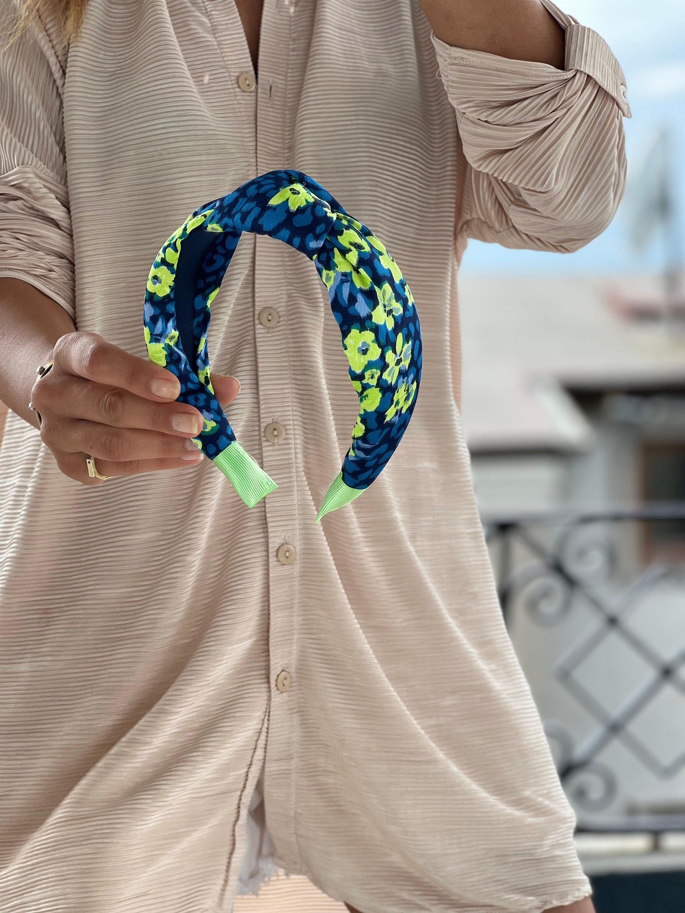 A stunning Blue, Bright Pink, and Green Headband made of soft and comfortable fabric.