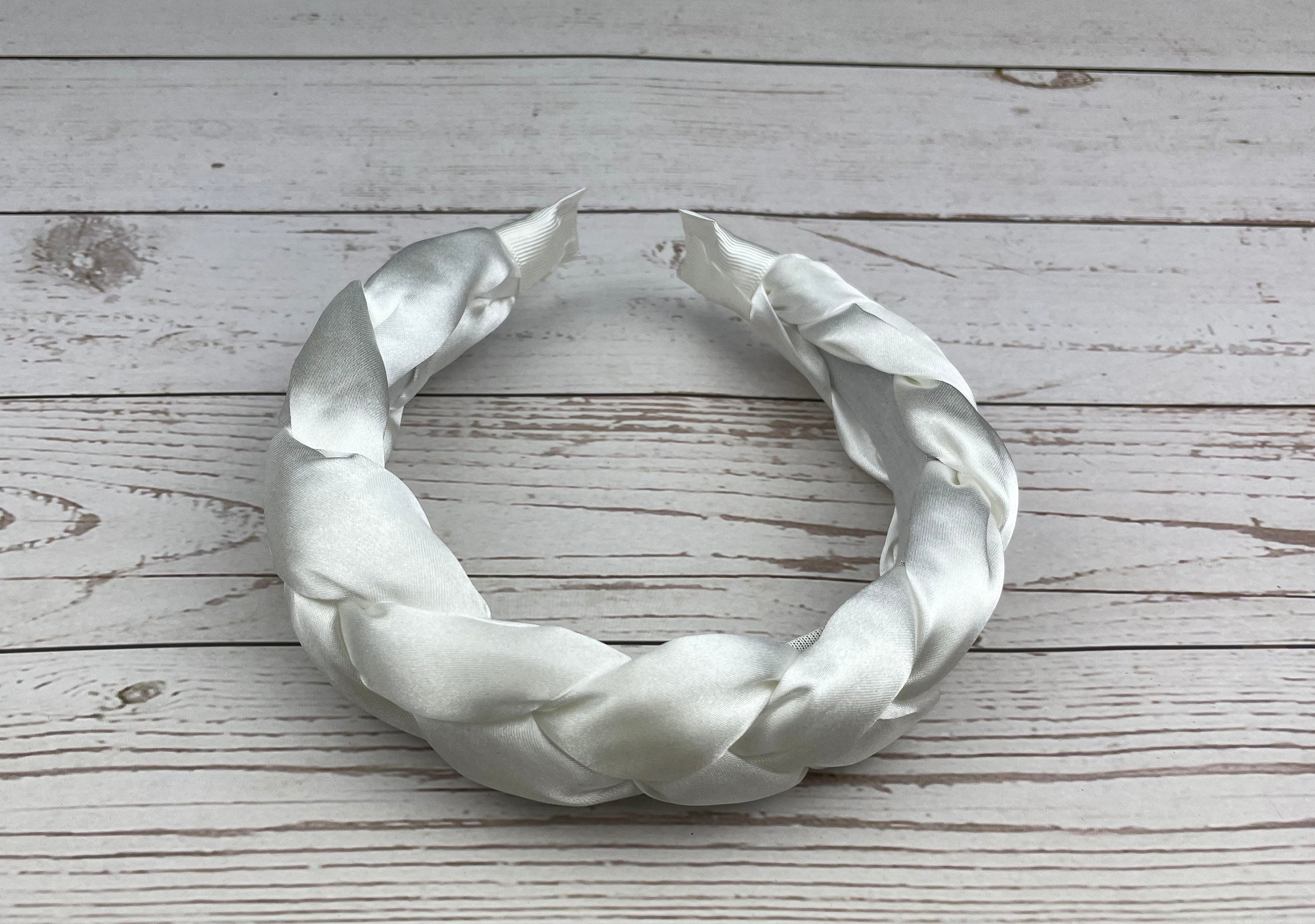 Stay comfortable and stylish at any celebration with this Snow White Padded Satin Knitted Headband for women. The perfect accessory for adding a touch of elegance to any outfit.