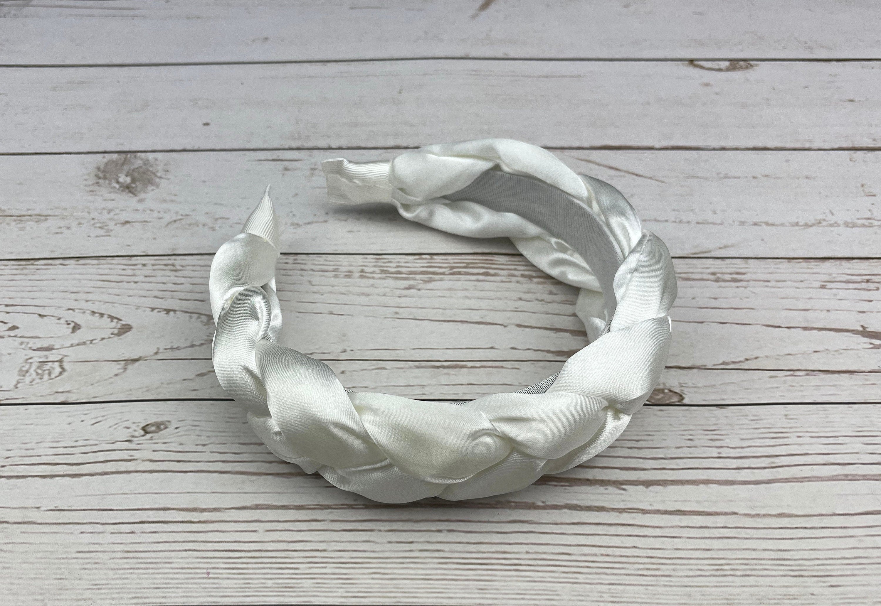 Celebrate in style with this elegant Snow White Padded Satin Knitted Headband, designed for women. The plush satin padding provides comfort and the knitted design adds a touch of sophistication to any celebration outfit.