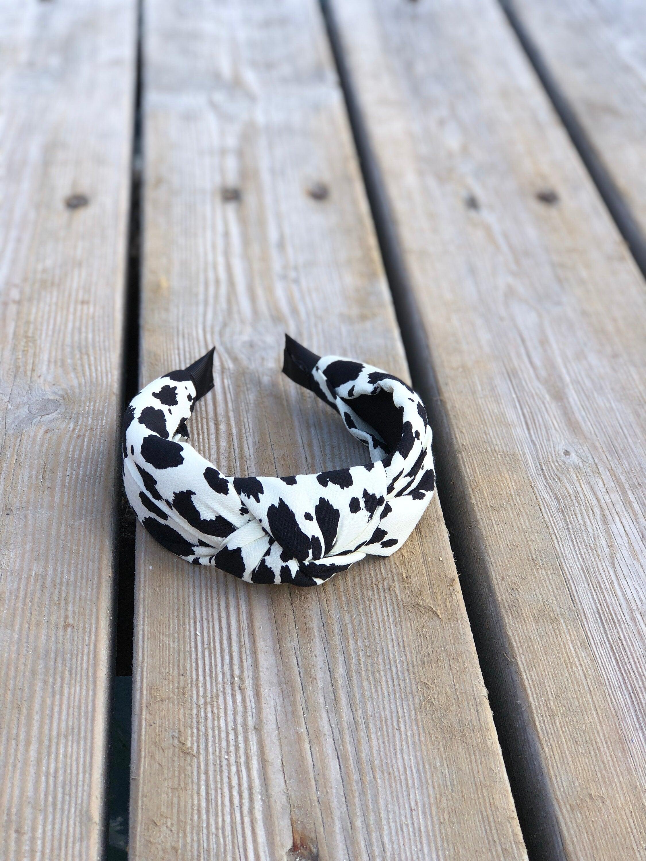 Elegant White Leopard Headband - Stylish African-Inspired Spotted Cotton Headband with Wide Design and Black Bow Accent available at Moyoni Design